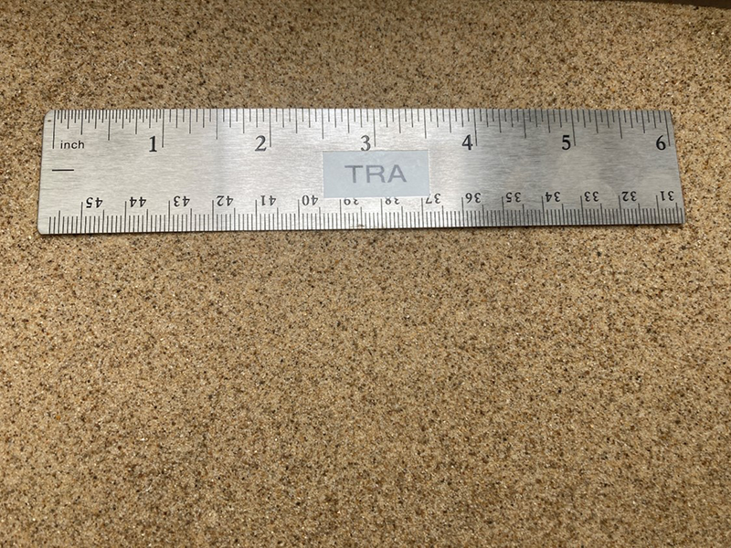 fine mason sand next to a ruler to show size