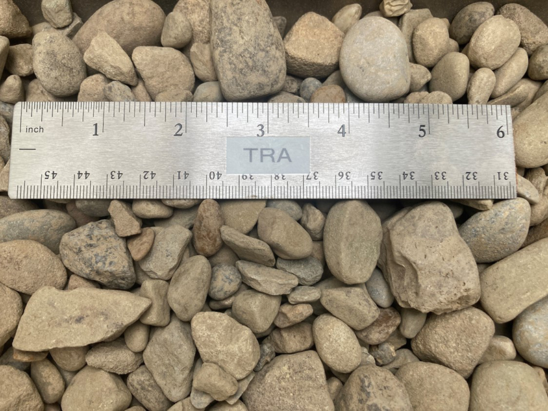 number 57 gravel at our aggregate supply yard next to a ruler to show size